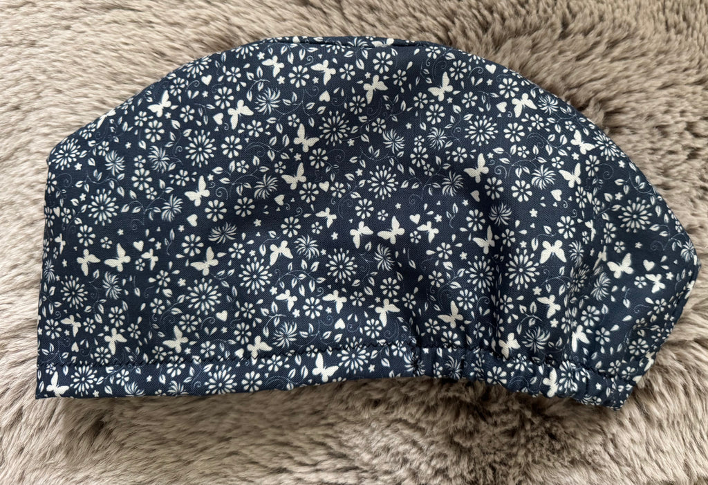 Navy and White Flower and Butterfly design Satin-lined fabric theatre scrub cap / hat.  Ethically made.