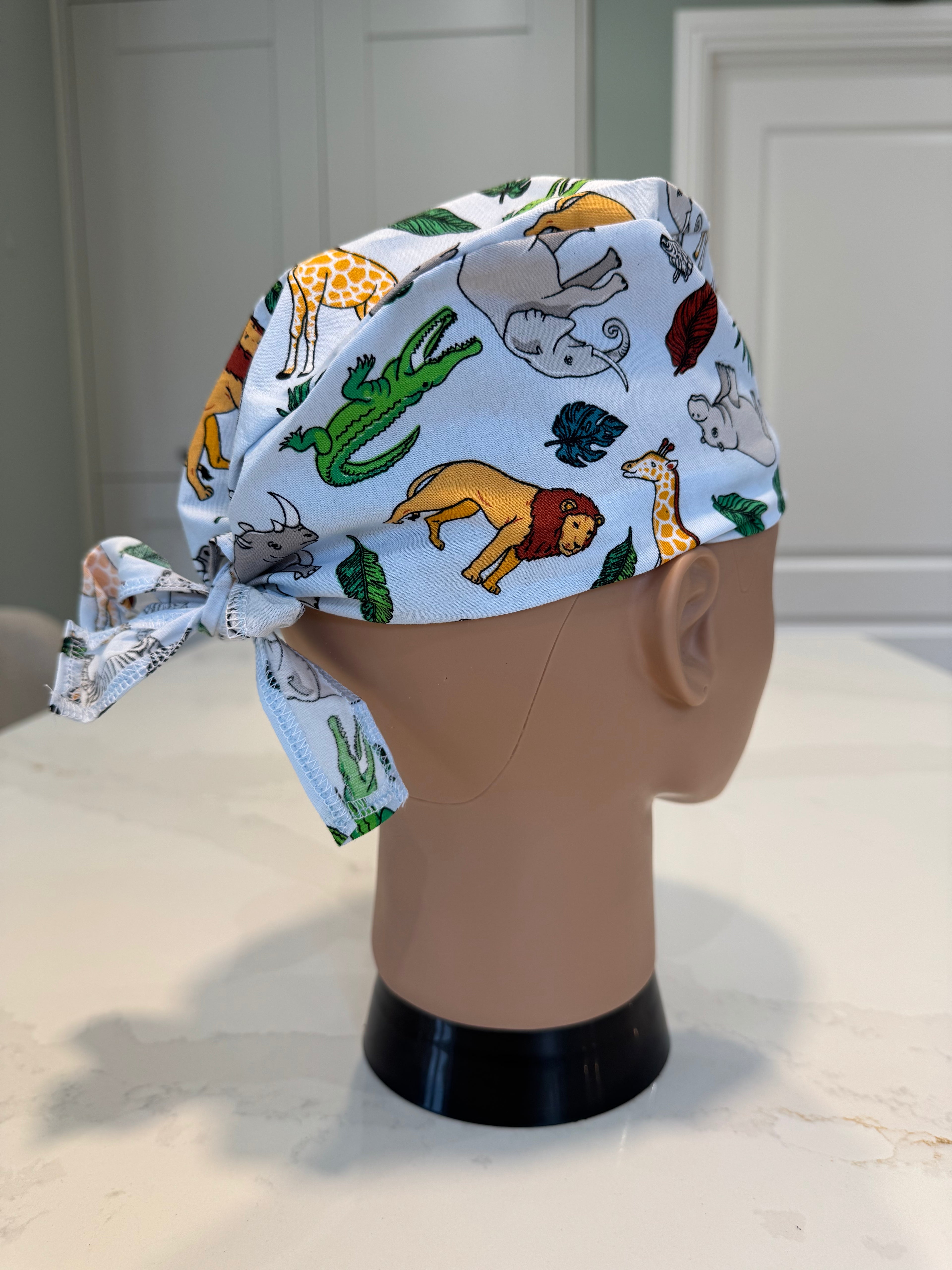 Pale blue Jungle Animals Cotton Fabric tie-back theatre scrub cap / hat.  Ethically made.