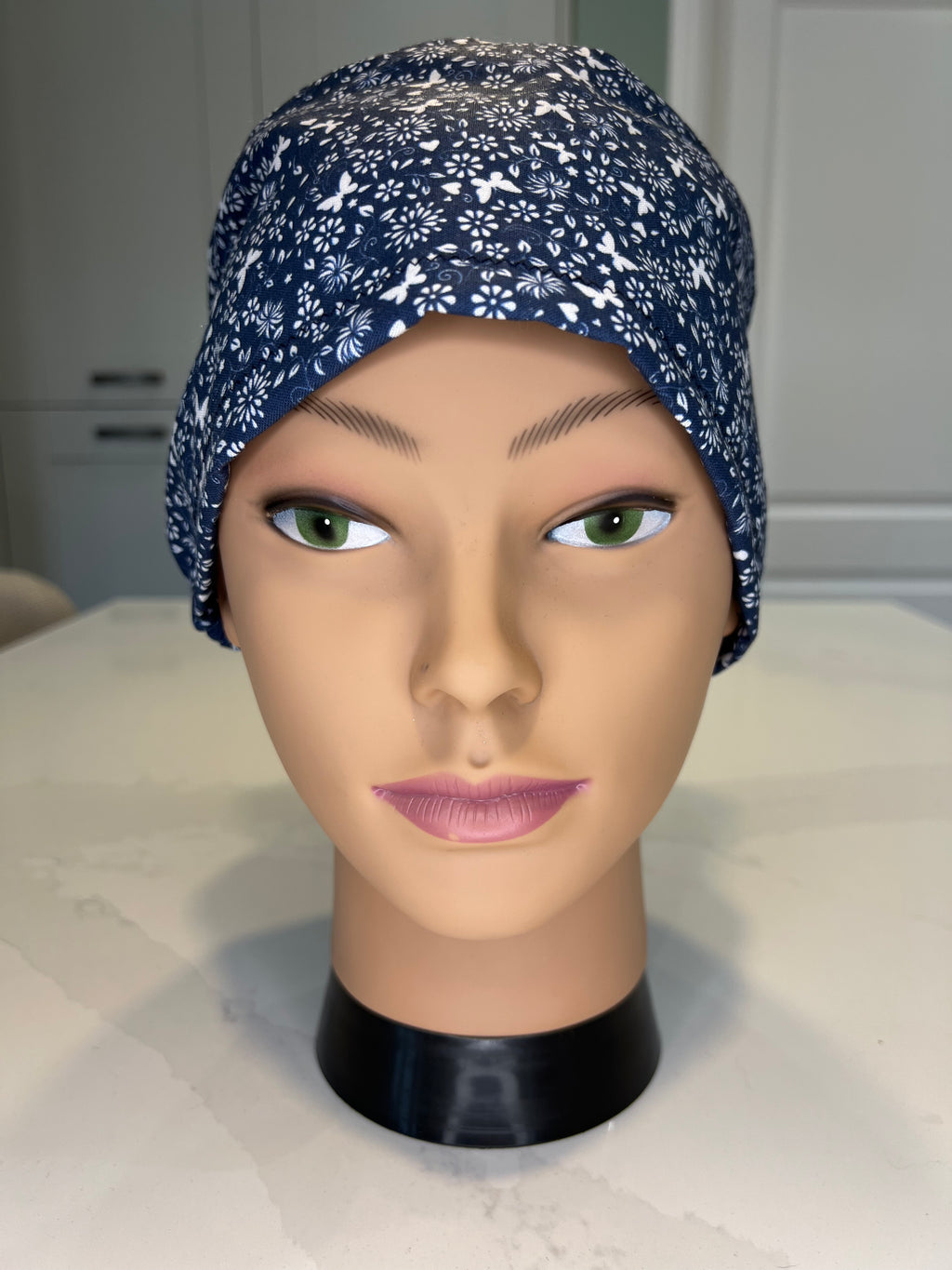Navy and White Flower and Butterfly design Satin-lined fabric theatre scrub cap / hat.  Ethically made.