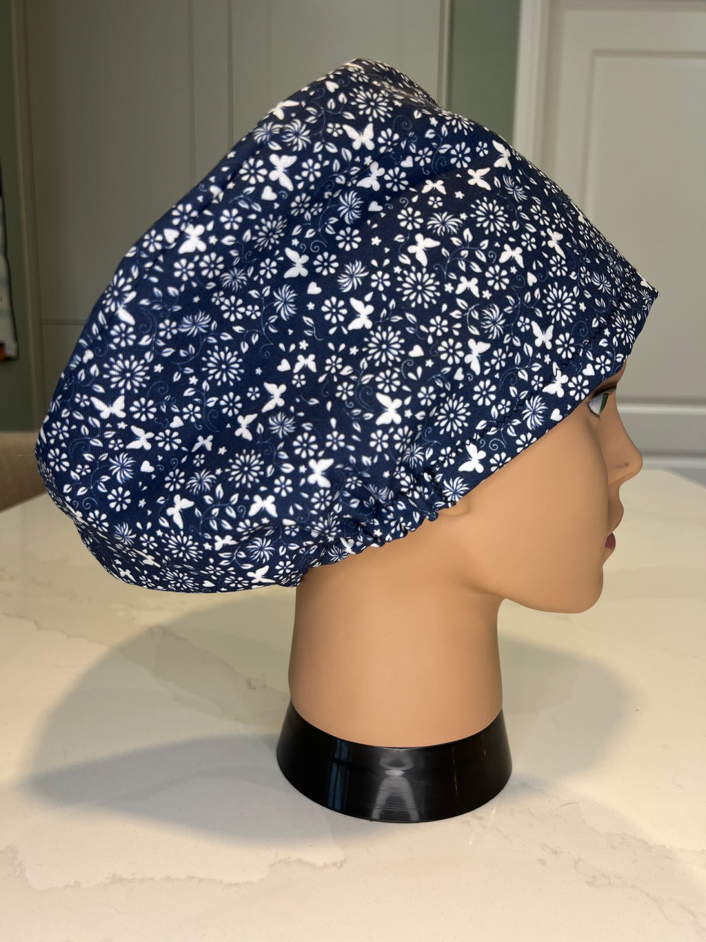 Navy and White Flower and Butterfly design Satin-lined fabric theatre scrub cap / hat.  Ethically made.