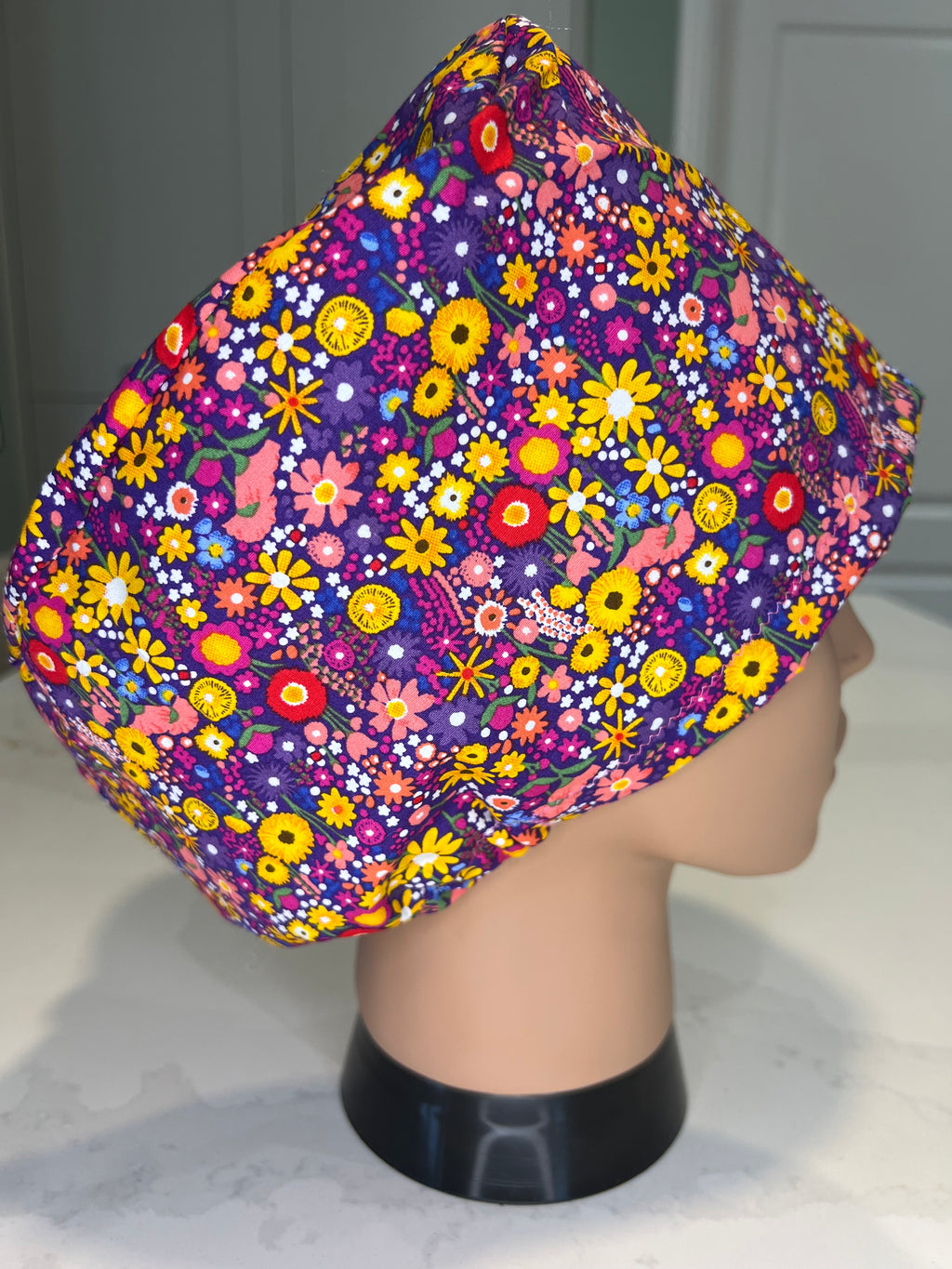 Purple vibrant ditsy flower patterned Satin-lined fabric theatre scrub cap / hat.  Ethically made.
